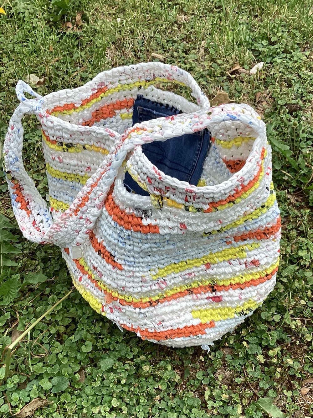 Handmade from plastic bags crocheted shopping tote bag with a pocket